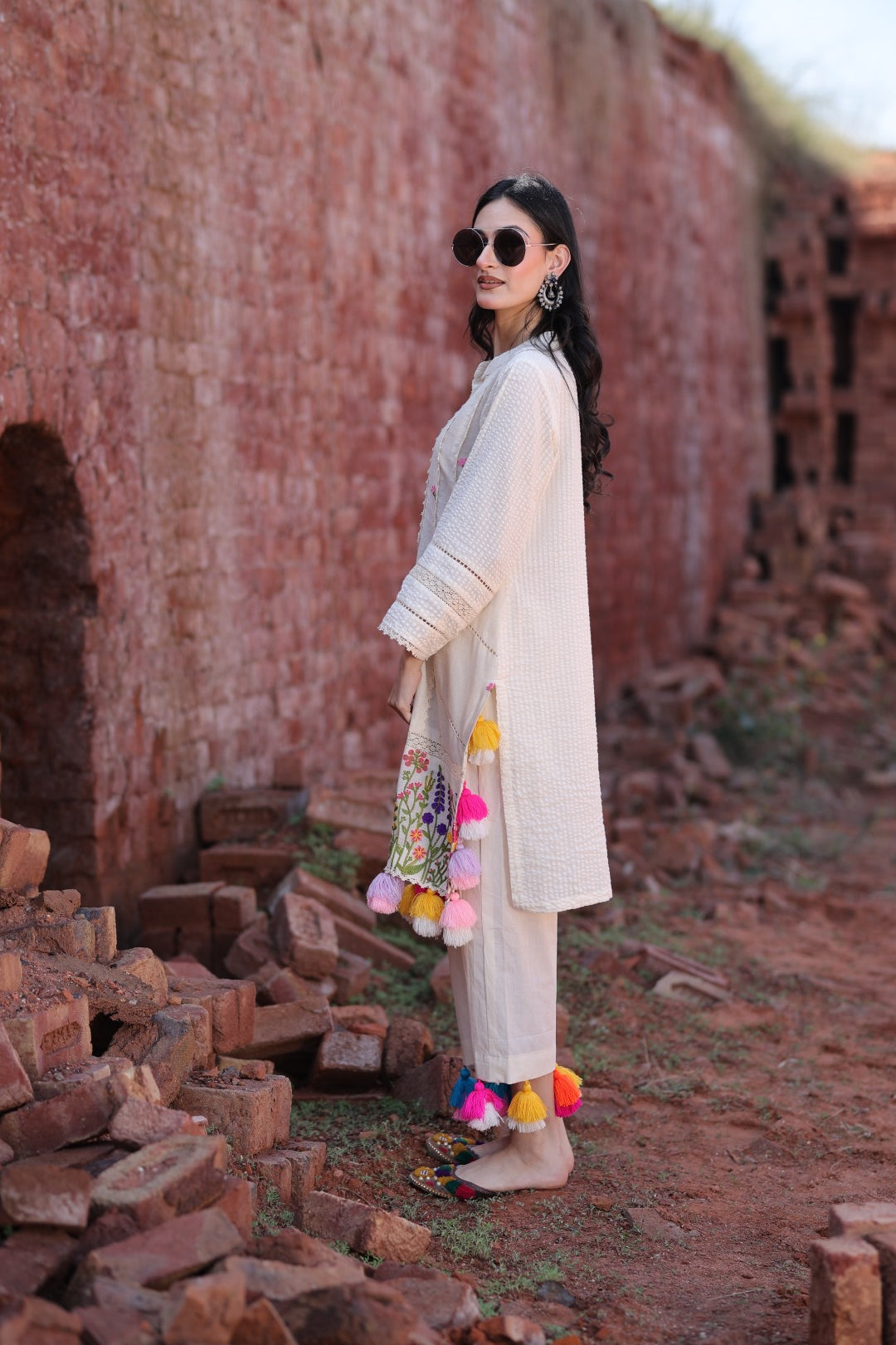 Side pose highlighting sleeve panels, earring, and embroidery profile.