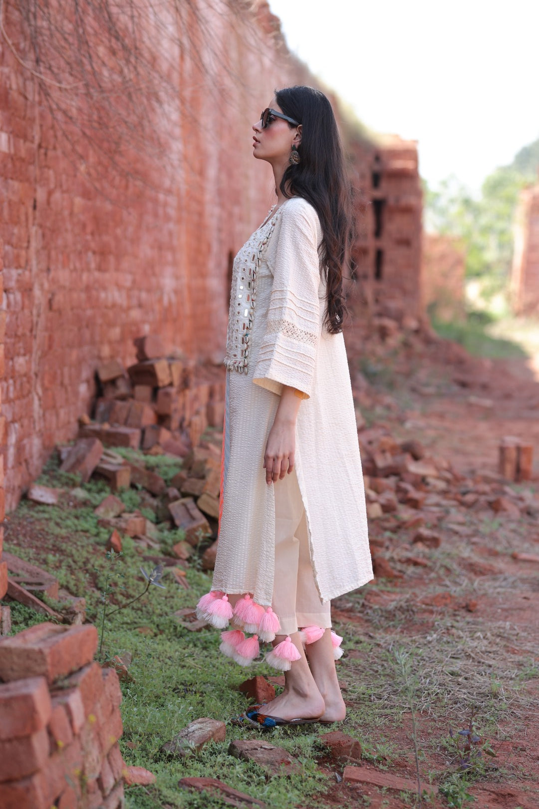 Subtle side flare showing pastel patch detailing and embroidery textures.