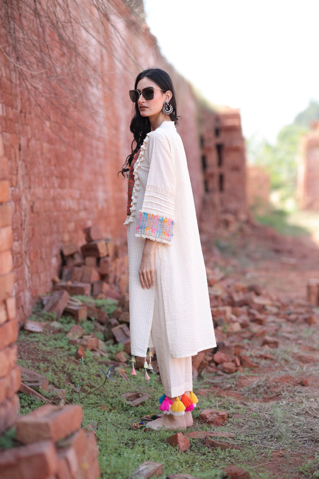 Side profile with flowing tassels and cuff details visible.