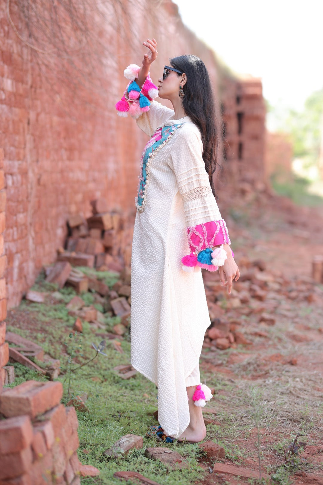 Side profile showcasing sleeve detailing and tassels