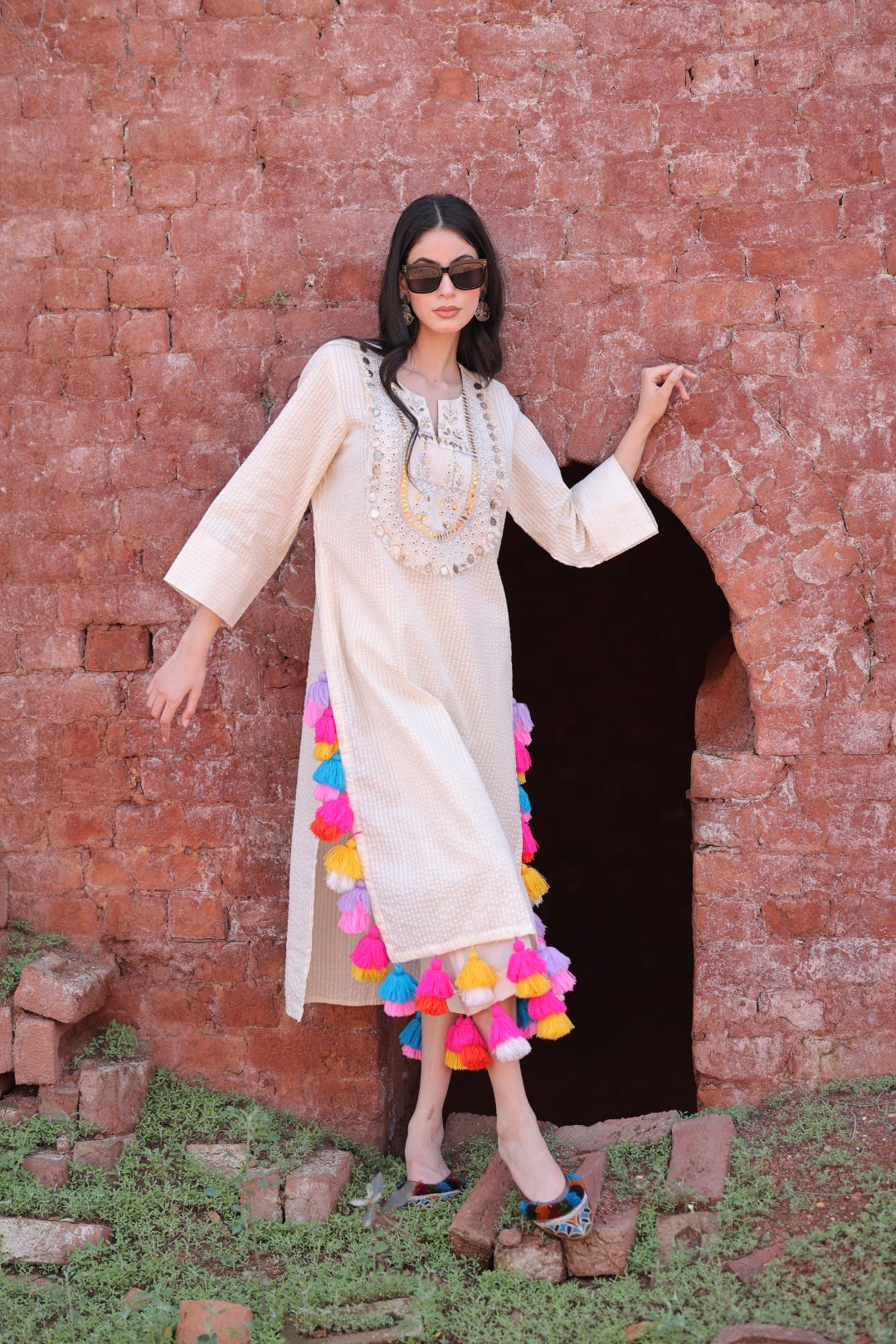 Right side view highlighting sleeve cut and tassel layering