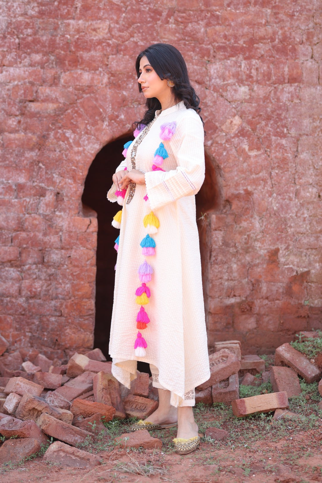 Side profile showing sleeve texture and tassel fall