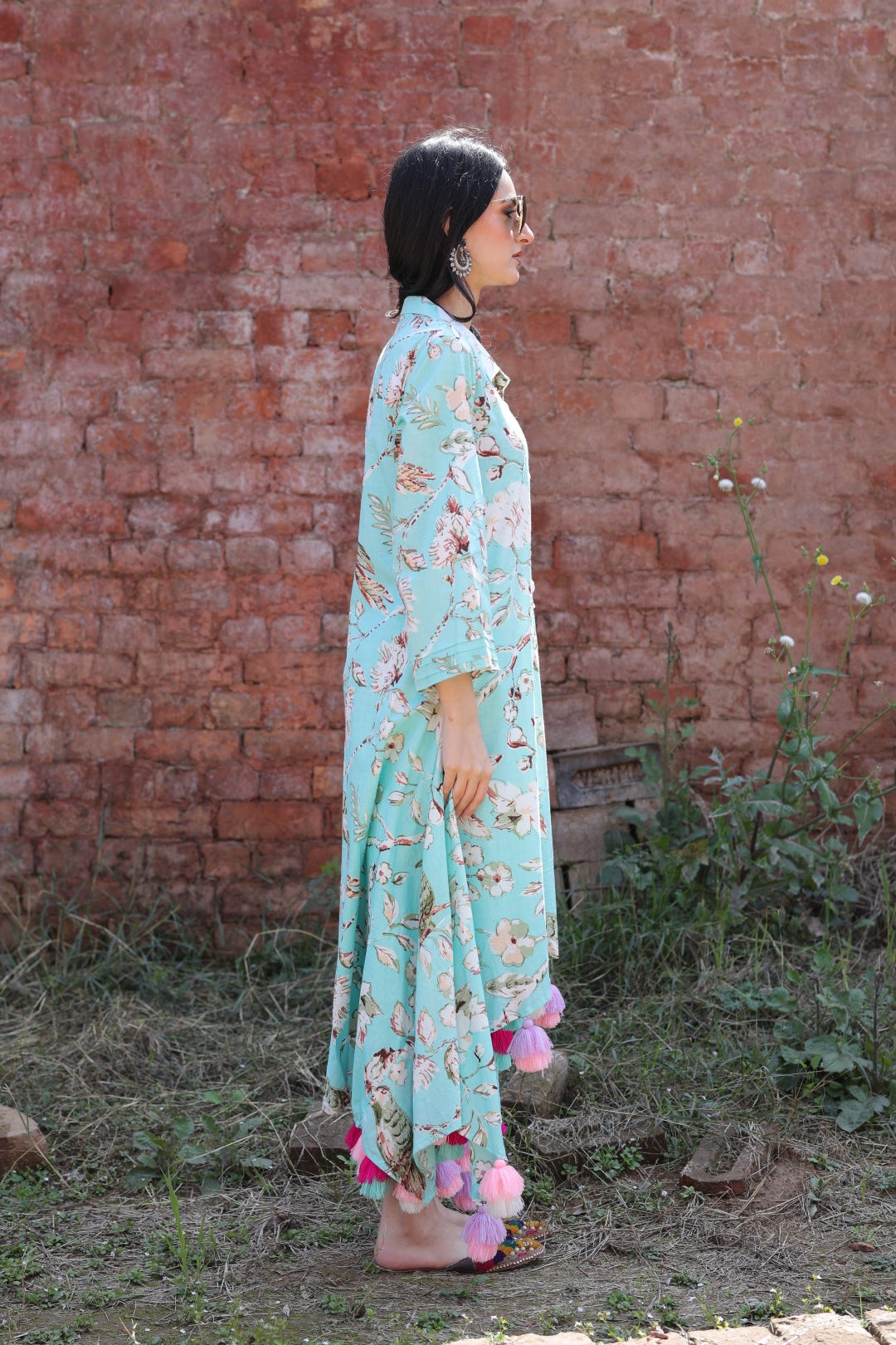 Right profile with soft fabric drape and colourful tassels