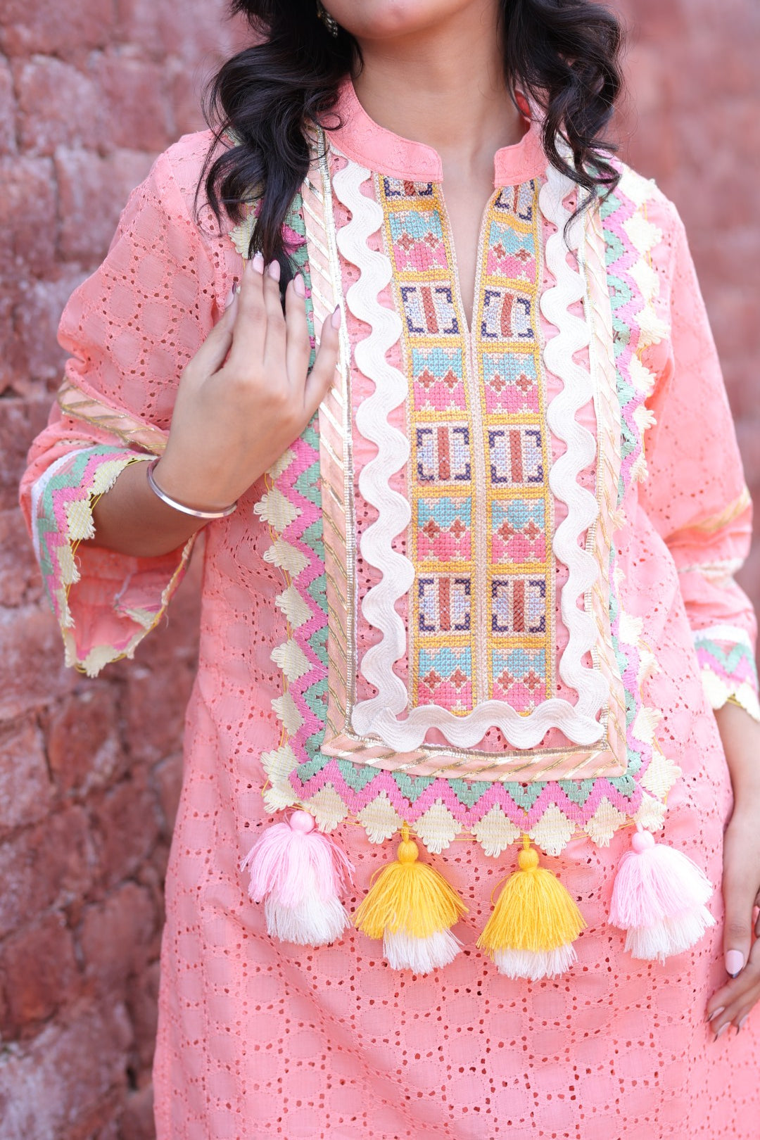 Close-up of embroidered yoke, mirror work, and handmade tassels