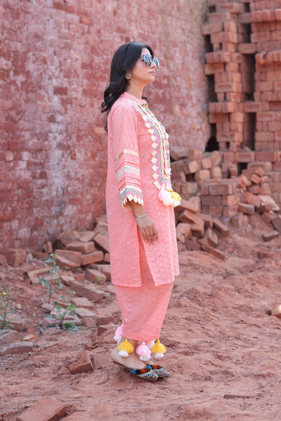 Model in movement showing tassels on pant hem and sleeve