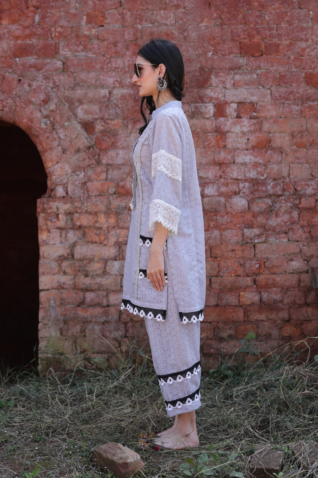 Side profile showcasing bell sleeves and lace detail