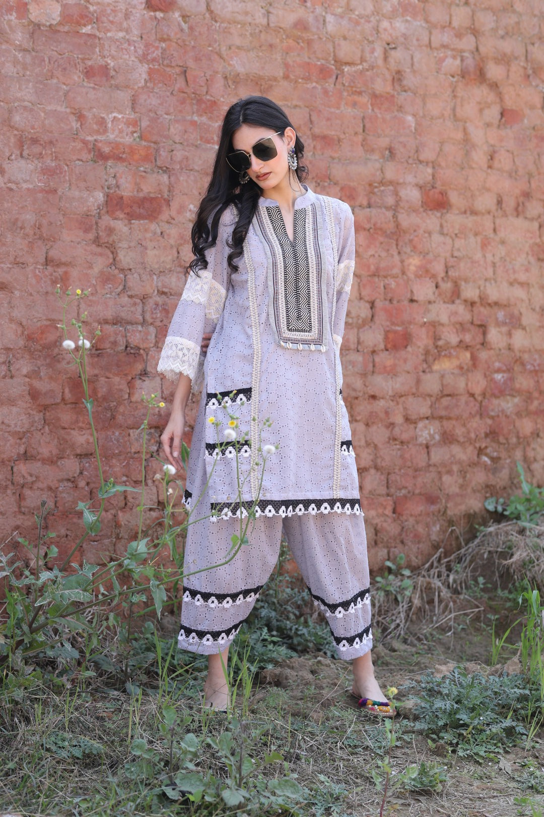 Model in lilac co-ord set with embroidered placket and lace details