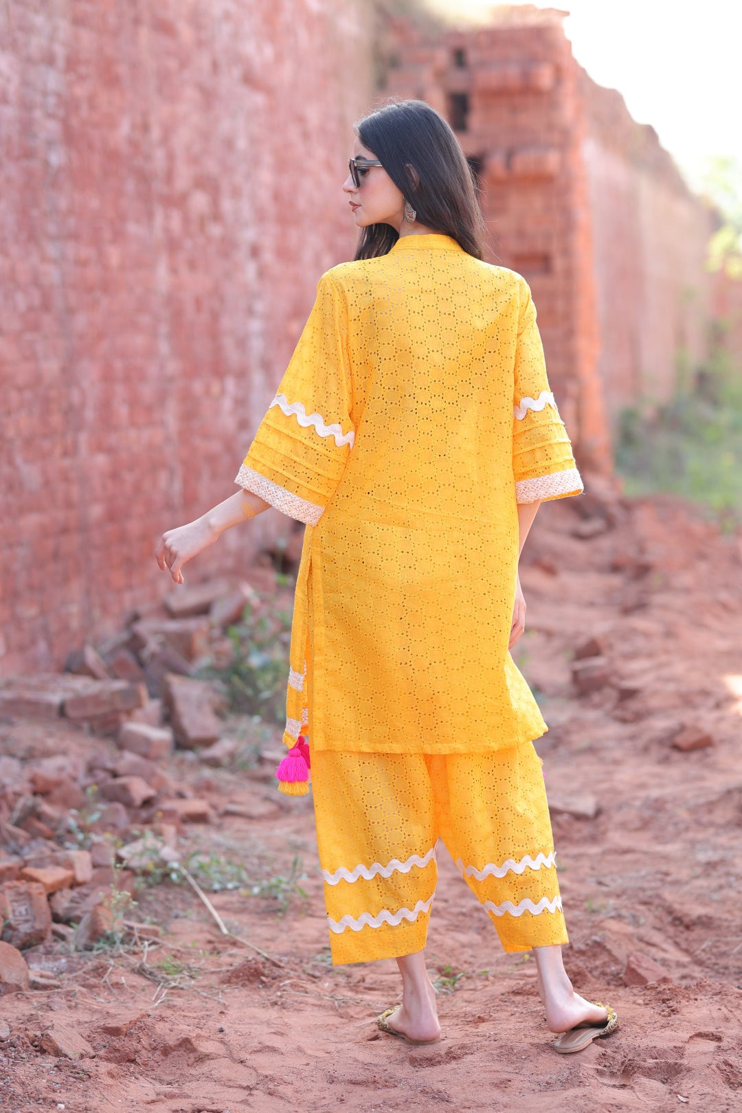 Mustard kurta back view with lace trims and chikankari detailing