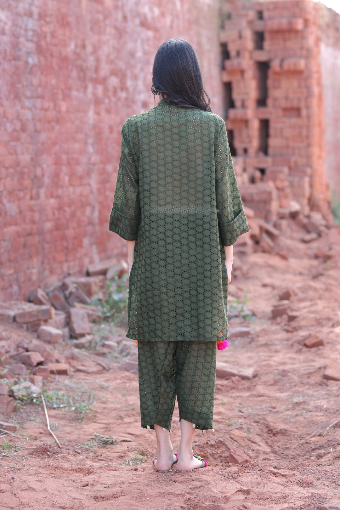 Back view of olive kurta with subtle texture and straight pants