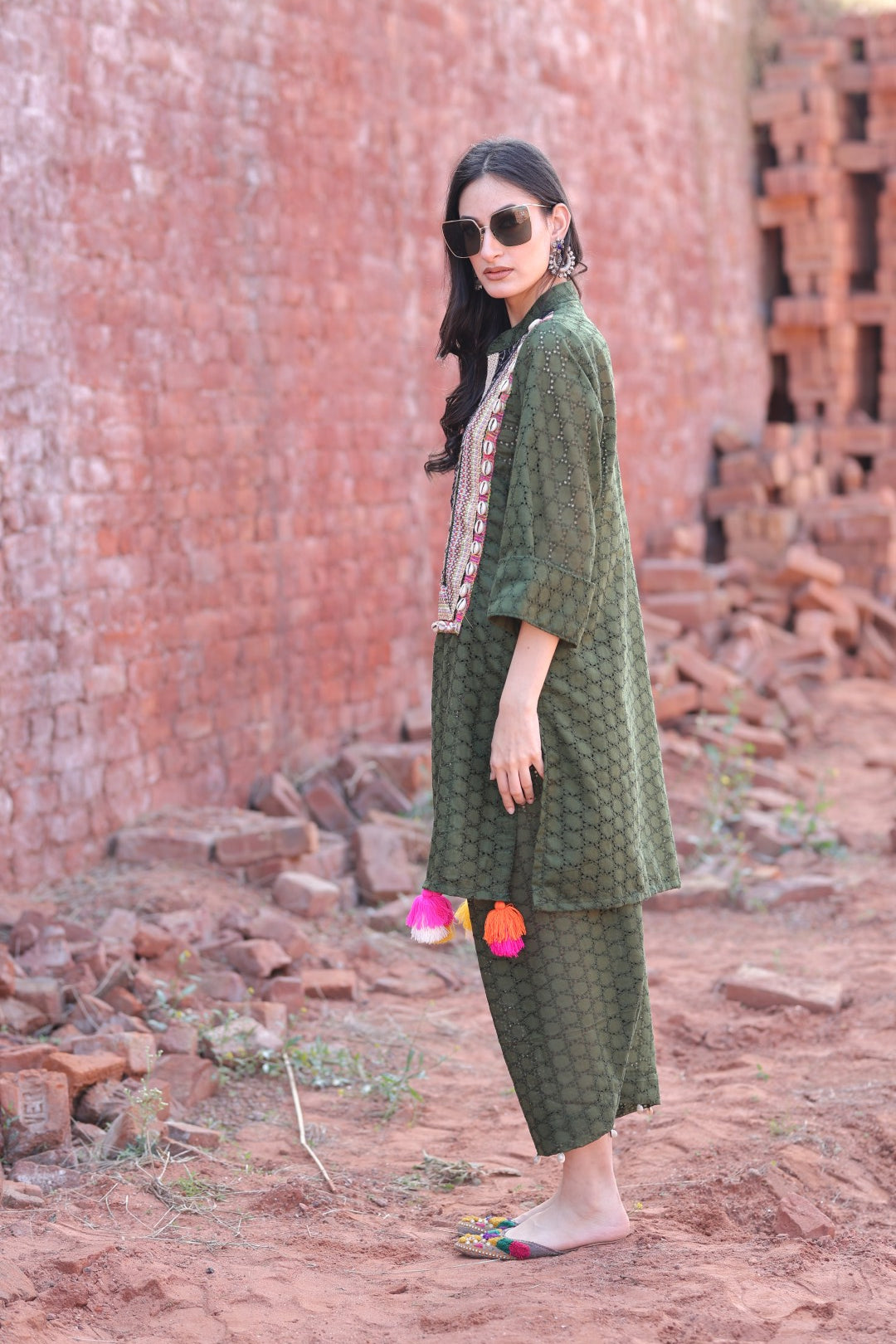 Side profile showing flow of kurta and tassels on pant hem
