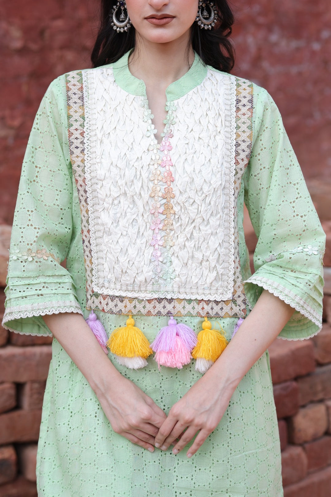 Close-up of mirror placket, embroidered panel & tassel detailing