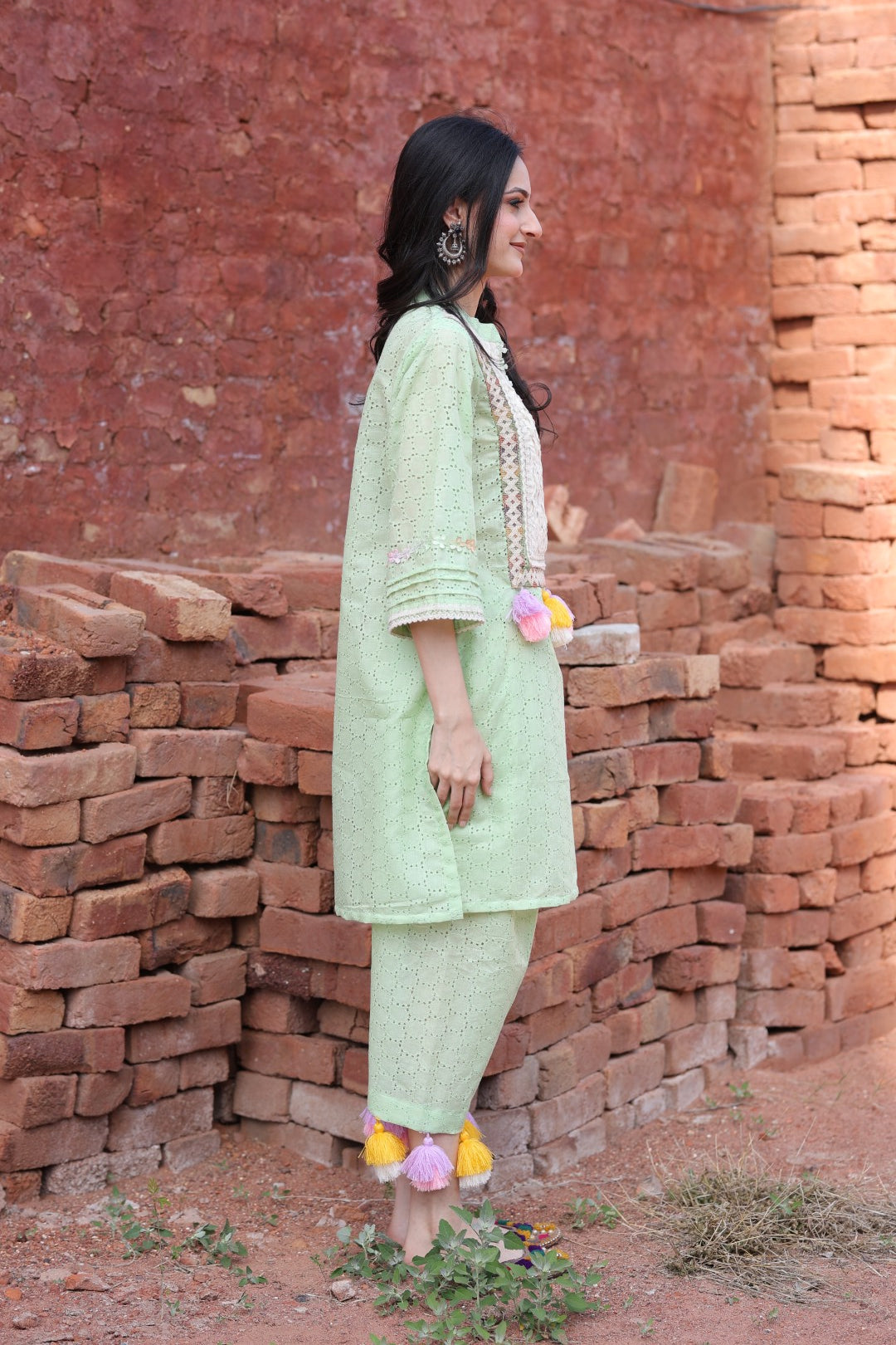 Right profile showcasing tassel play and pants’ cut