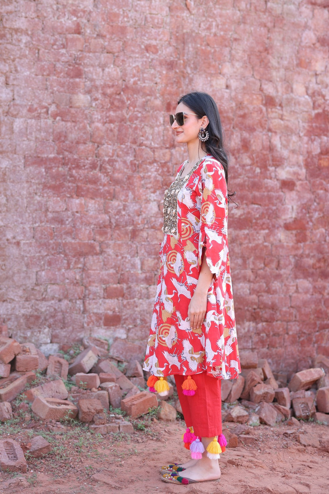 Side angle showing 3/4th sleeves and movement of tassels