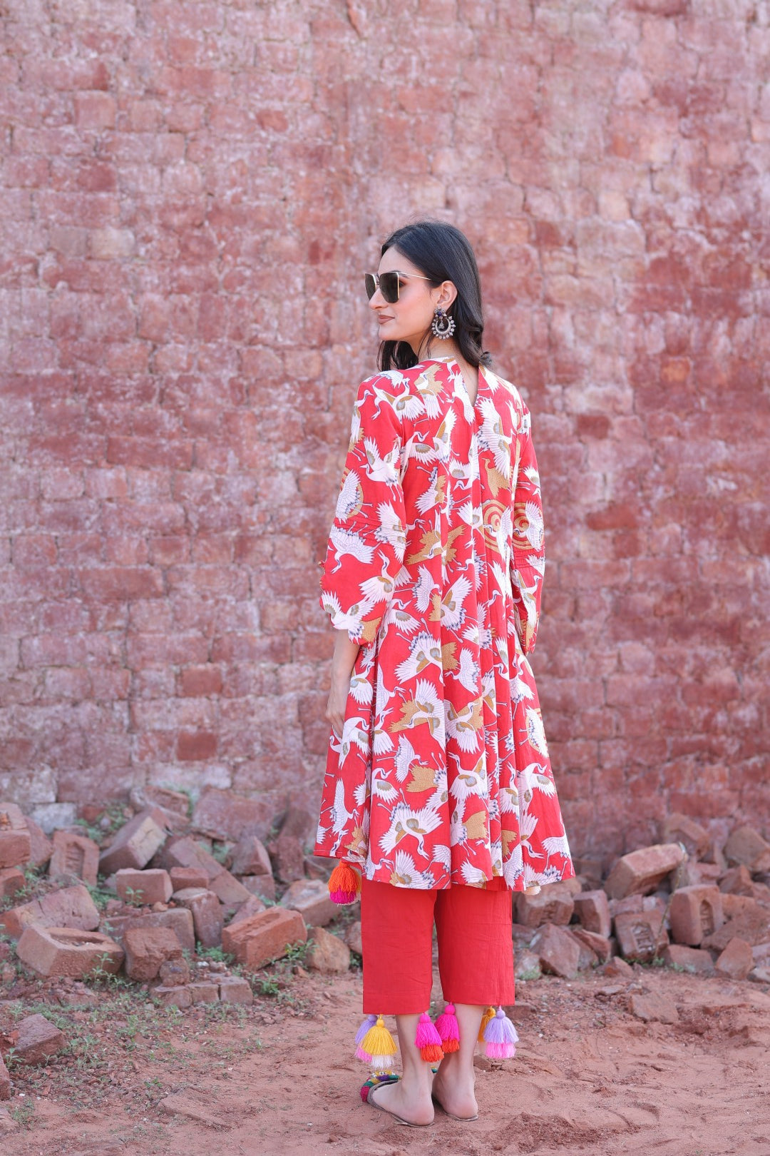 Back view of red kurta showing print and tassel detail