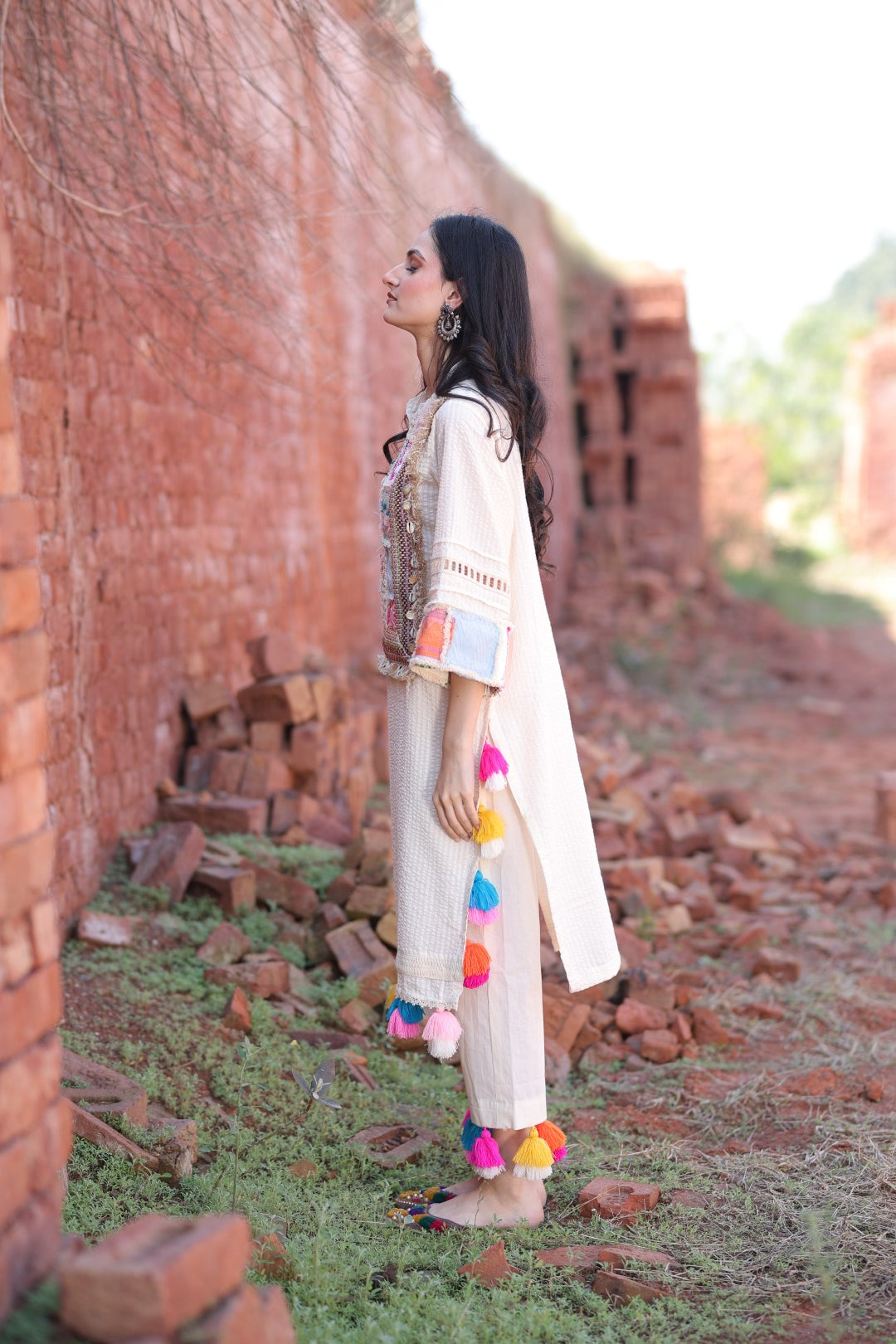 Left profile showing tassel placement and patch detailing on sleeve
