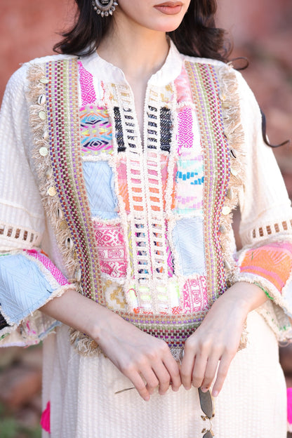 Close-up of patch embroidery in multicolour threads and mirror accents