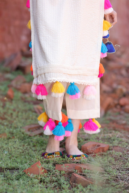 Close-up of patch embroidery in multicolour threads and mirror accents