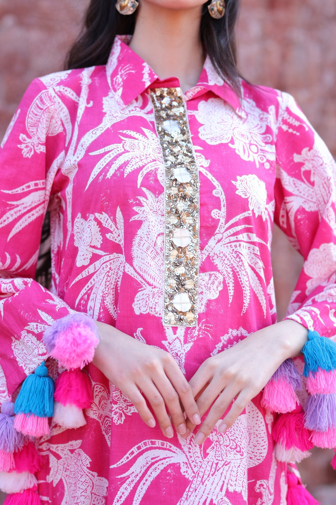 Close-up of mirror placket, tropical print and tassel craftsmanship